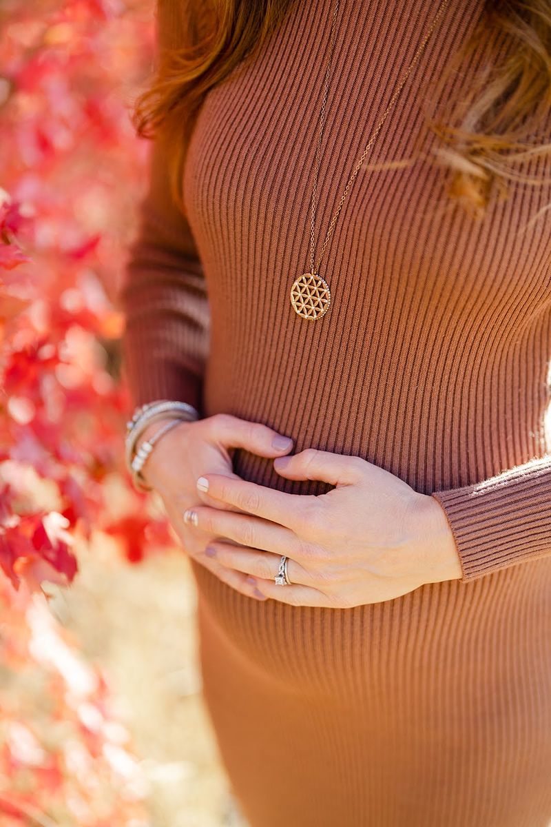 Sybille's hands resting on her pregnant belly